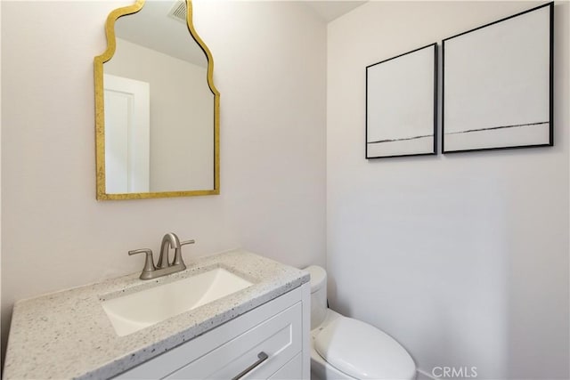 bathroom with toilet and vanity