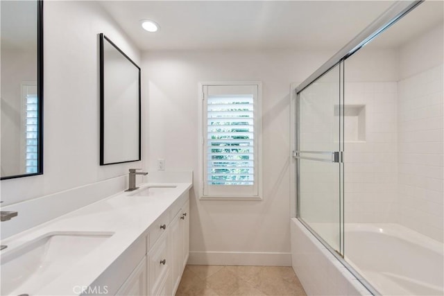 bathroom with tile patterned floors, combined bath / shower with glass door, and vanity