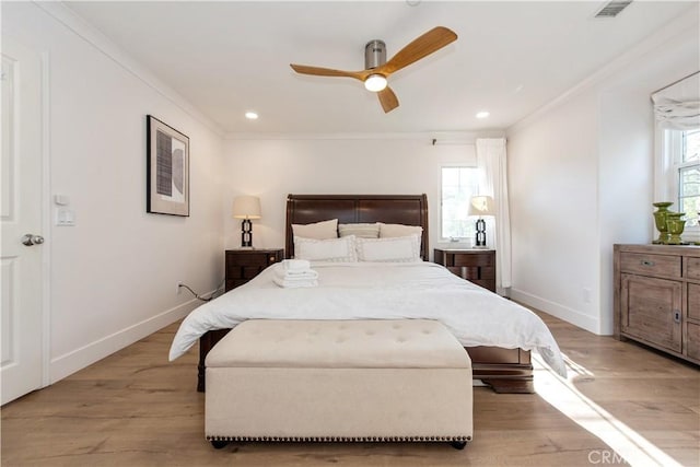 bedroom featuring ceiling fan, ornamental molding, and light hardwood / wood-style floors