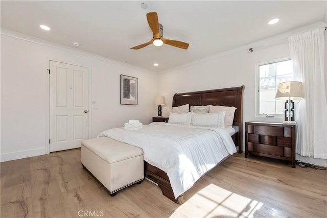 bedroom featuring ceiling fan, ornamental molding, and light wood-type flooring