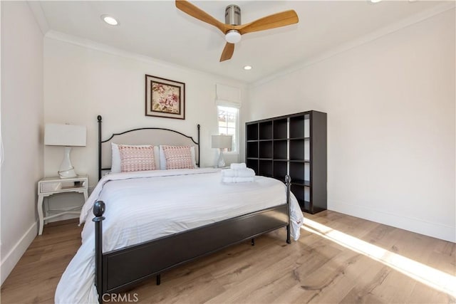 bedroom with ceiling fan, ornamental molding, and light hardwood / wood-style flooring