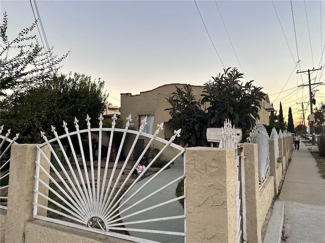 view of gate at dusk