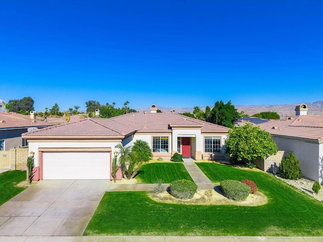 view of front of property featuring a garage and a front lawn