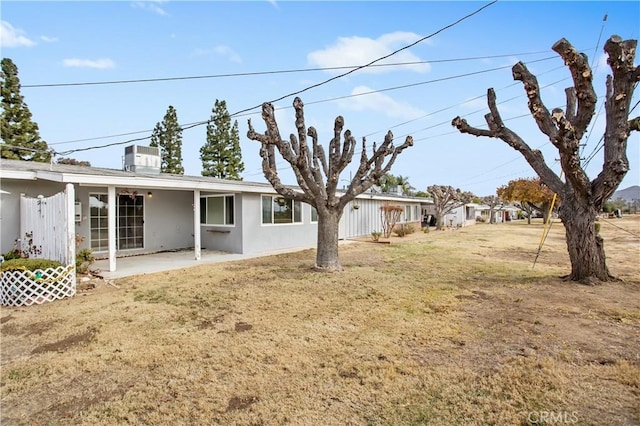 view of yard featuring central AC and a patio area