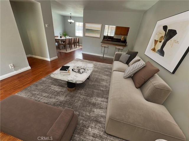 living room featuring dark hardwood / wood-style floors and a chandelier