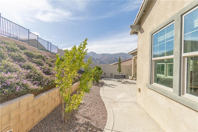 view of patio / terrace featuring a mountain view