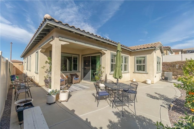 11121 Fourleaf Ct, Corona, CA 92883 - rear view of property featuring stucco siding, a patio, a tiled roof, a fenced backyard, and outdoor dining area