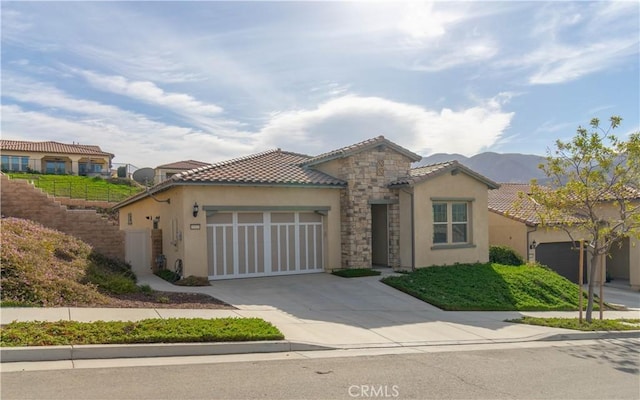 11121 Fourleaf Ct, Corona, CA 92883 - mediterranean / spanish home with stucco siding, a garage, concrete driveway, a tile roof, and a mountain view