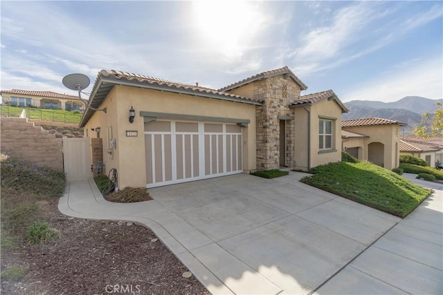 11121 Fourleaf Ct, Corona, CA 92883 - mediterranean / spanish house featuring driveway, an attached garage, stucco siding, a mountain view, and a tile roof