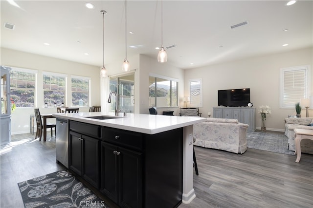 11121 Fourleaf Ct, Corona, CA 92883 - kitchen featuring dark cabinetry, wood finished floors, open floor plan, light countertops, and recessed lighting