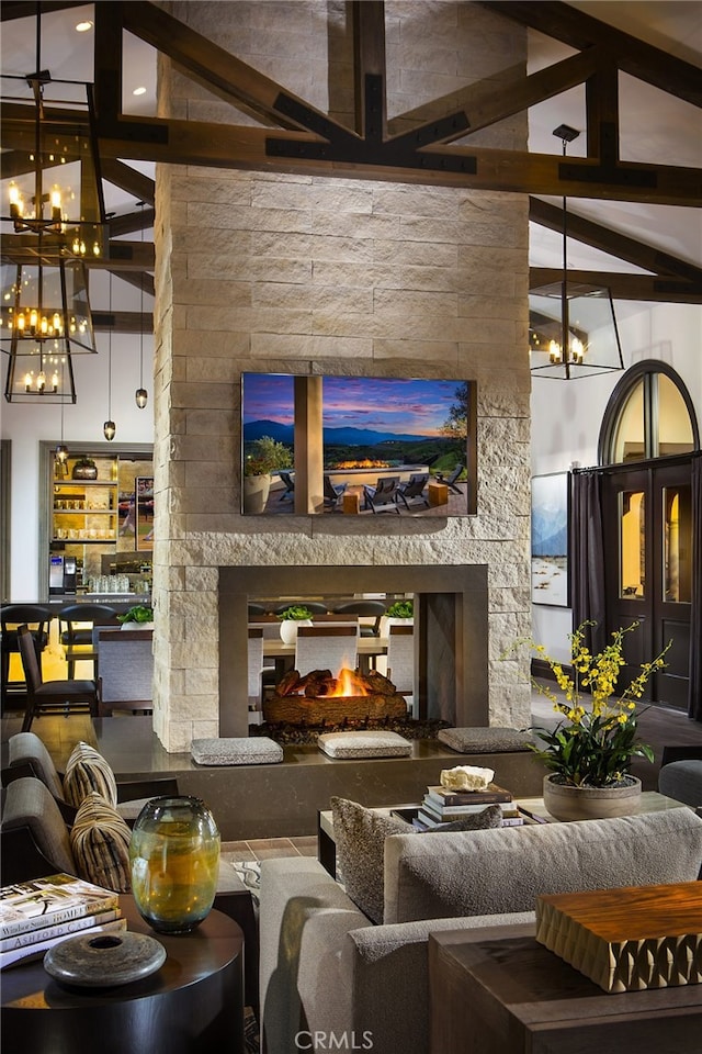 11121 Fourleaf Ct, Corona, CA 92883 - living area featuring a chandelier, a stone fireplace, and beam ceiling