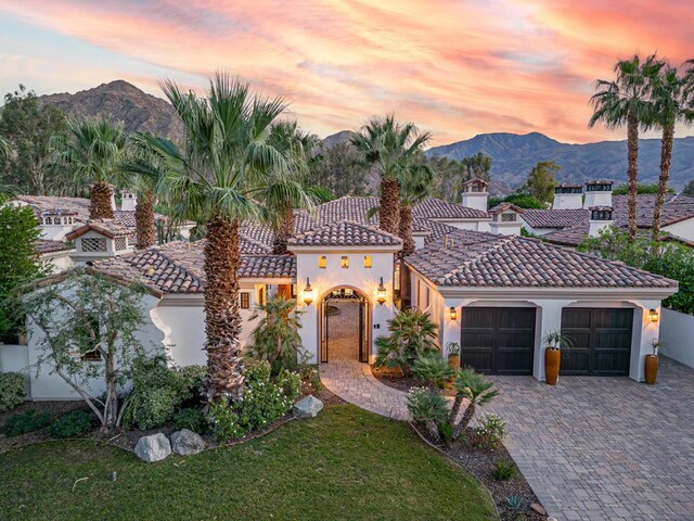 mediterranean / spanish-style house with a mountain view and a garage