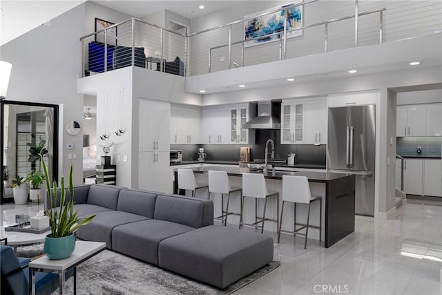 living room with a towering ceiling and sink