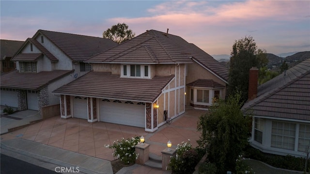 view of front of property featuring a garage and a mountain view