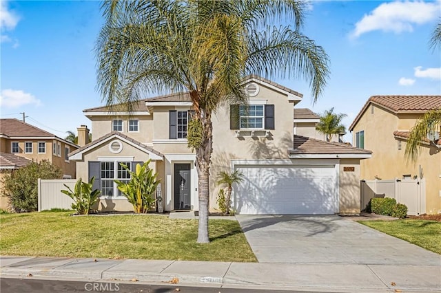 mediterranean / spanish house featuring a front yard and a garage