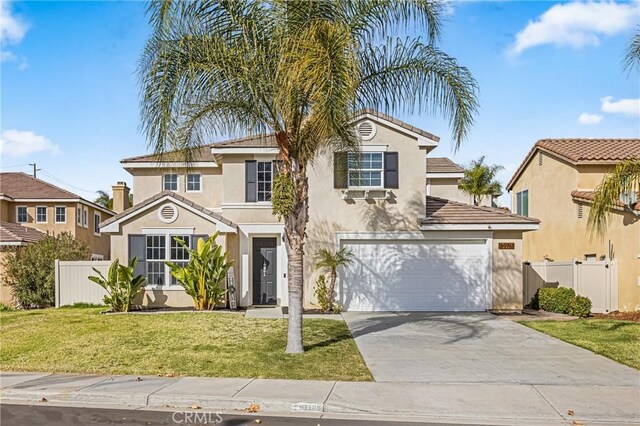 mediterranean / spanish house featuring a garage and a front lawn