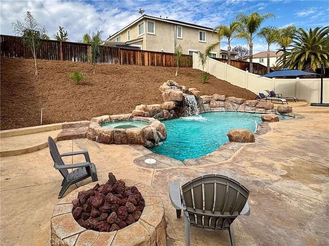 view of swimming pool featuring a patio area and an in ground hot tub