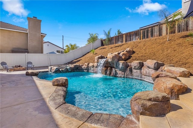 view of pool with a patio and pool water feature