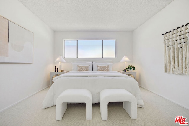 carpeted bedroom with a textured ceiling