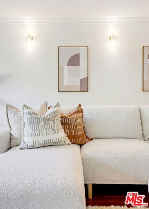 bedroom with ornamental molding and a nursery area