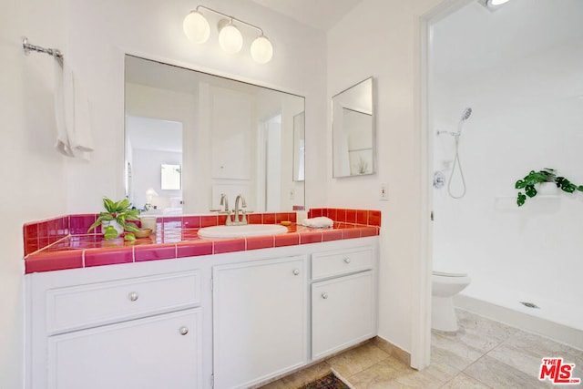 bathroom featuring a shower, toilet, and vanity