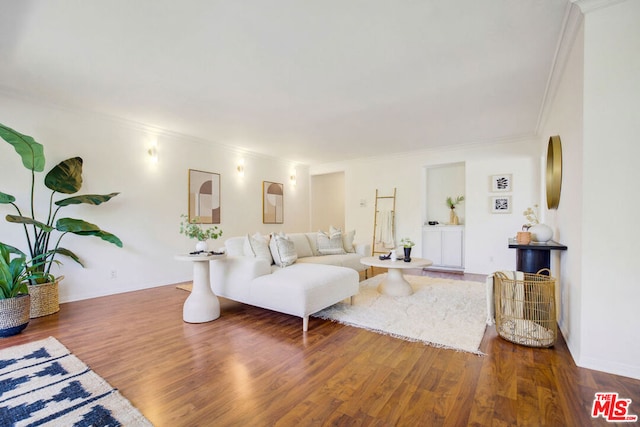 living room with hardwood / wood-style floors and crown molding