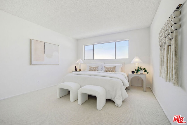 carpeted bedroom featuring a textured ceiling