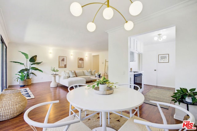 dining area with dark wood-type flooring and ornamental molding