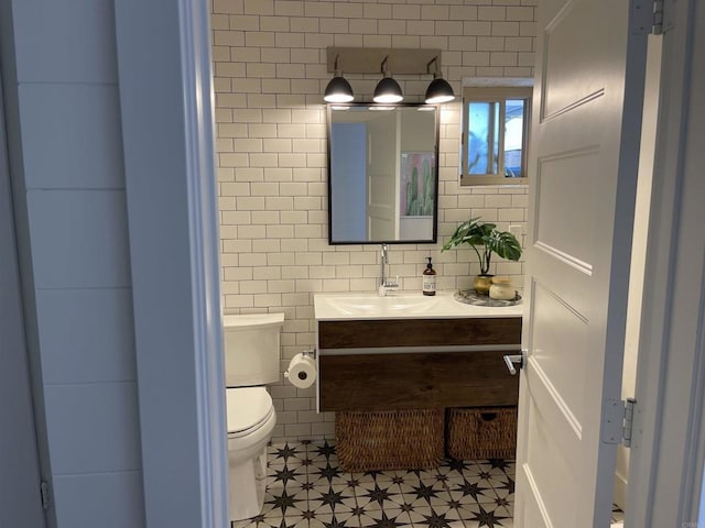 bathroom featuring toilet and vanity