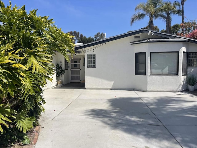 view of side of property with a patio