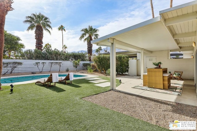 exterior space with a patio and a fenced in pool