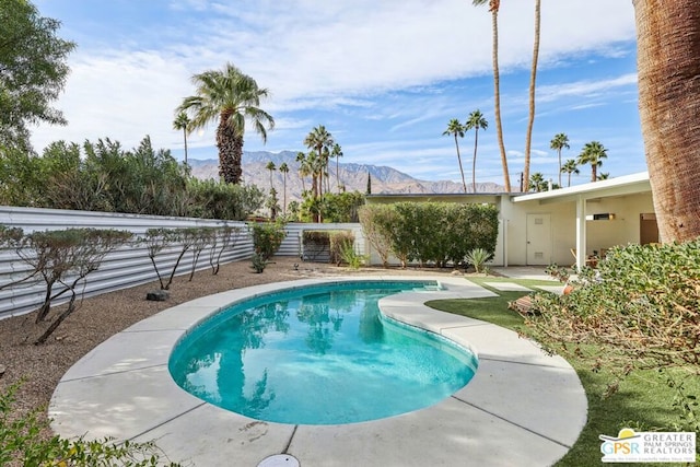 view of swimming pool featuring a mountain view