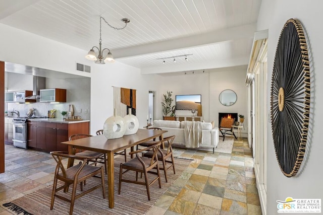 dining area with wood ceiling, a notable chandelier, and beamed ceiling