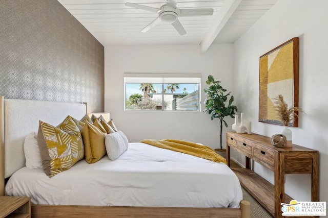 bedroom featuring ceiling fan and beamed ceiling