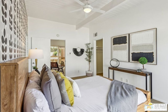 bedroom with ceiling fan, a walk in closet, wood ceiling, and beam ceiling