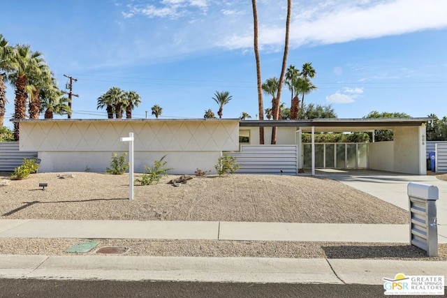 ranch-style house featuring a carport