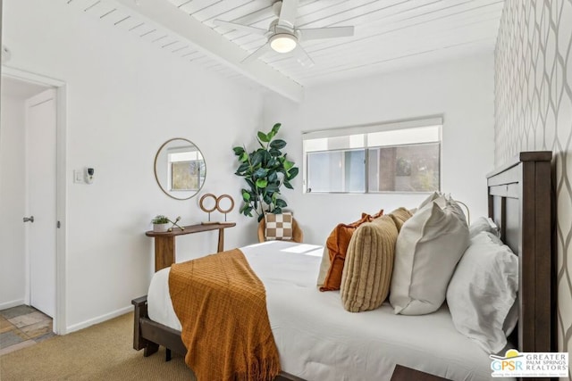 carpeted bedroom with ceiling fan, wooden ceiling, and beamed ceiling