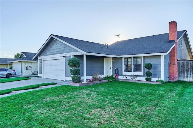 single story home featuring a front lawn and a garage