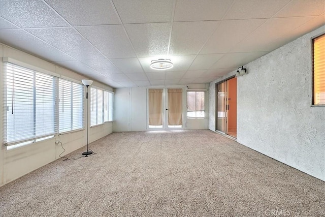 carpeted empty room featuring french doors