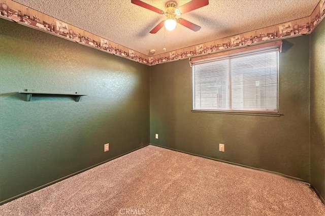 carpeted spare room featuring ceiling fan and a textured ceiling