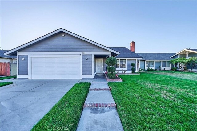 ranch-style house with a front yard and a garage