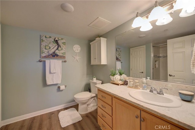 bathroom with vanity, toilet, wood-type flooring, and an enclosed shower