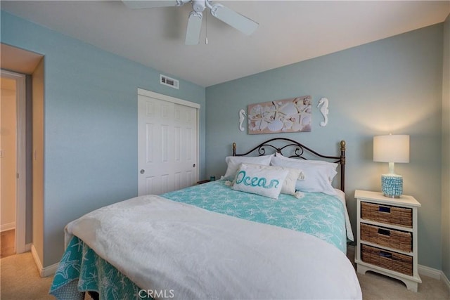 carpeted bedroom featuring a closet and ceiling fan