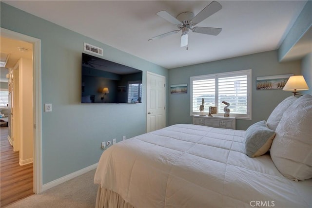 bedroom featuring ceiling fan and light carpet