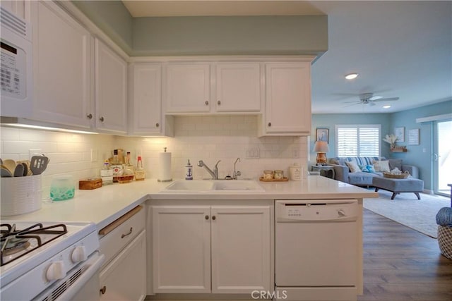 kitchen with ceiling fan, dark hardwood / wood-style floors, sink, white appliances, and white cabinetry