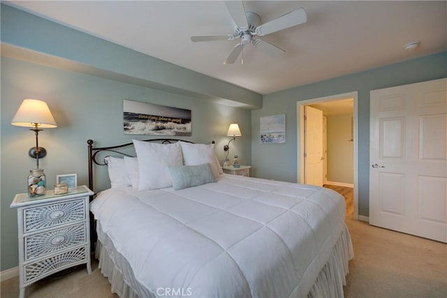 bedroom featuring light carpet and ceiling fan