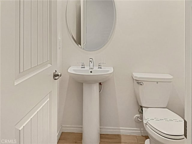 bathroom featuring hardwood / wood-style flooring and toilet