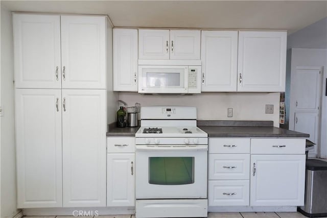 kitchen with white cabinetry and white appliances