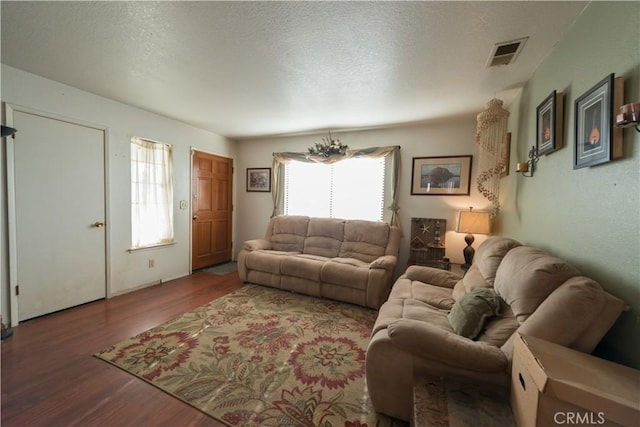 living room featuring hardwood / wood-style flooring and a textured ceiling