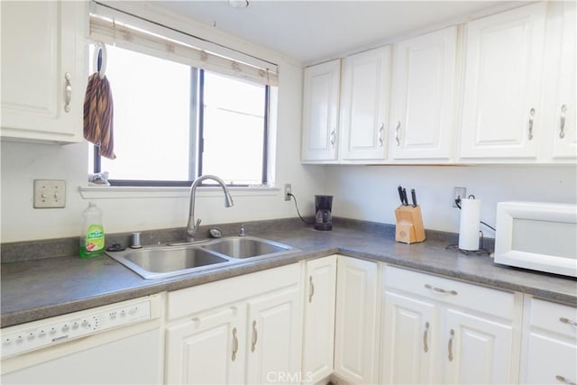 kitchen with sink, white appliances, and white cabinets